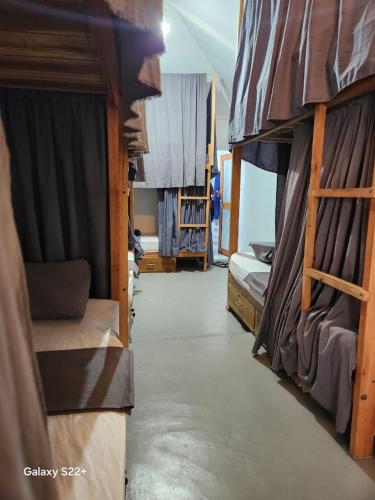 a room with several bunk beds in a room at Early birds in Arugam Bay