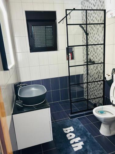 a bathroom with a shower and a toilet at Lux apartmani in Bihać