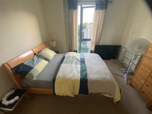 a bedroom with a bed and a window at Colindale Central Apartment in Colindale