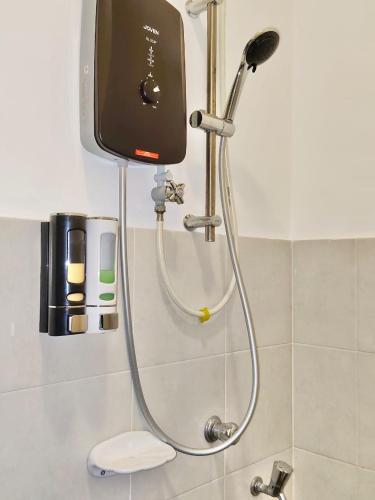 a shower in the corner of a bathroom at 25 Homestay Pulai in Johor Bahru