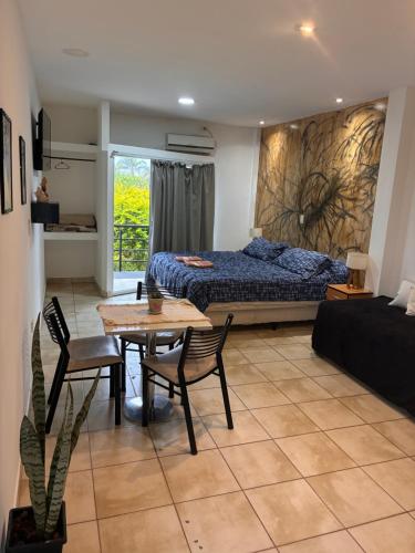 a bedroom with a bed and a table and chairs at a termas voy in Termas de Río Hondo