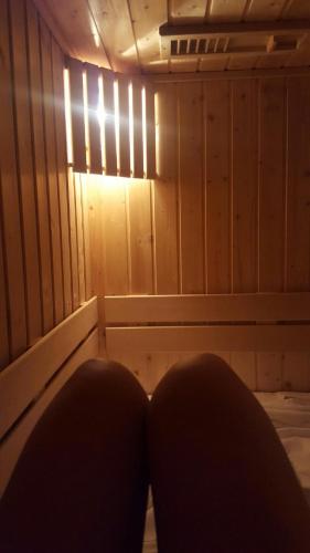 a person sitting in a sauna with a light at Apartments and Rooms With View on Bled in Bled