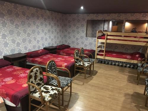 a room with four beds and a bunk bed at Tolli Hostel & Holiday House in Valga