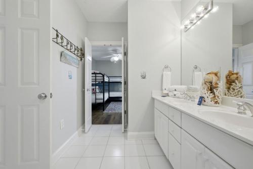 a white bathroom with a sink and a mirror at Riviera Dunes 201 in Perdido Key