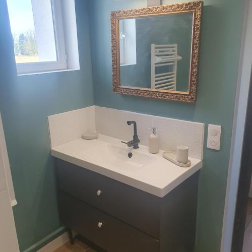 a bathroom with a sink and a mirror at La forge in Hinx