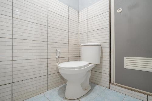 a bathroom with a toilet and a glass shower at The Cabin Artana By ARBA in Palayangan