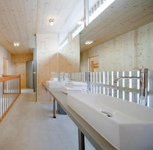 a bathroom with a row of sinks and mirrors at Ferienhaus Alpin in Neustift im Stubaital