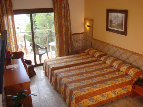 Posteľ alebo postele v izbe v ubytovaní Hotel Univers