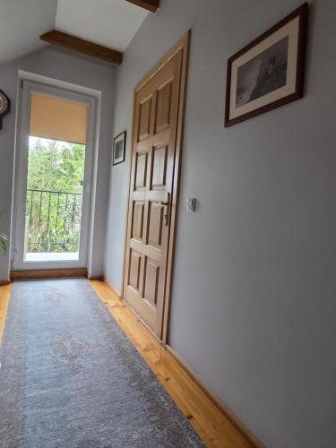 an empty room with a door and a rug at Molas svečių namai in Klaipėda