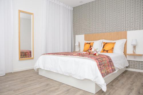 a bedroom with a bed with a teddy bear on it at The Marketplace by Storytellers in Funchal