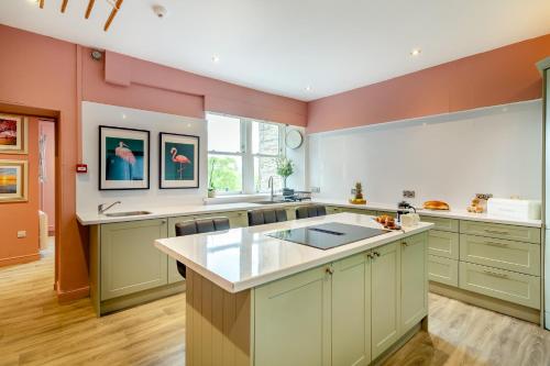 a large kitchen with pink and green walls at The Haven, Leyburn in Leyburn
