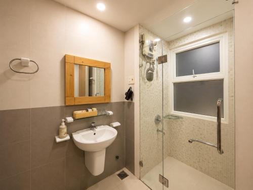 a bathroom with a sink and a shower and a toilet at Saigon Quiet Stay in Ho Chi Minh City