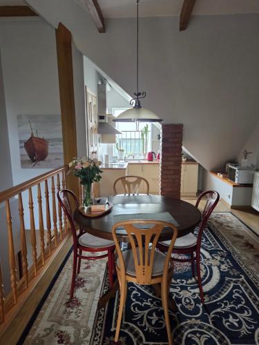 a kitchen and dining room with a table and chairs at Molas svečių namai in Klaipėda