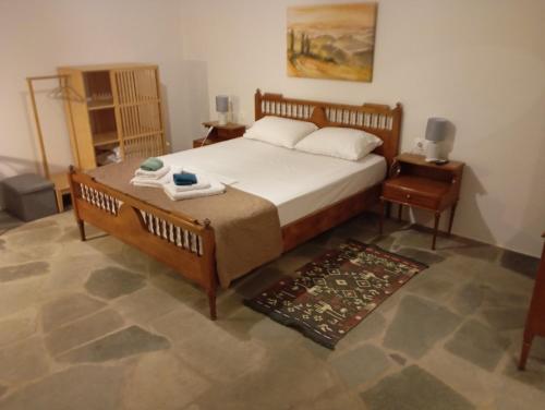 a bedroom with a large bed and a rug at Blue Agave in Agios Sostis