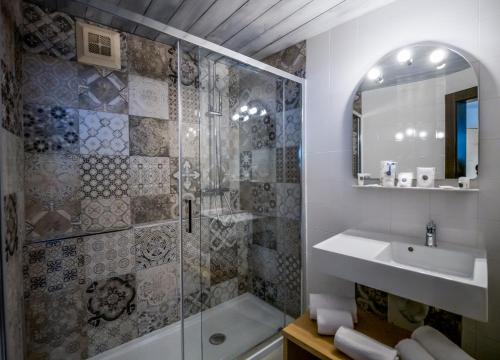 a bathroom with a shower and a sink at Family Hotel Schloss Rosenegg in Fieberbrunn