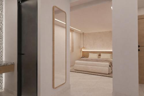 a bedroom with a large mirror and a bed at Theera by Premium Key in Skiathos