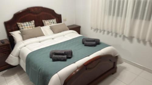 a bedroom with a large bed with two pillows on it at Refugio Rural A Revolta in Bergazo
