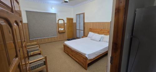 a bedroom with a bed and a chalkboard and a chalkboard at Basera Lodges in Nathia Gali