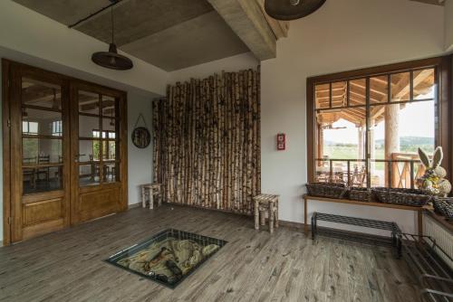 a living room with a wooden floor and windows at Kompleks Małe Dolomity in Hucisko