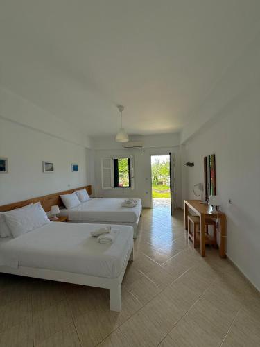 a large room with two beds and a table at Green House in Himare