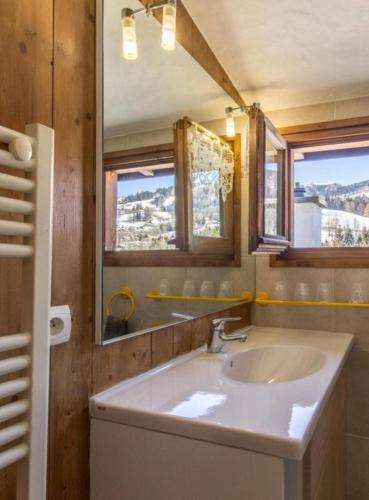 a bathroom with a sink and a mirror at Chalet l'Aiglon in Saint-Gervais-les-Bains