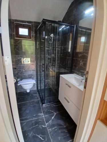 a bathroom with a shower and a sink at On Hotel in Adrasan