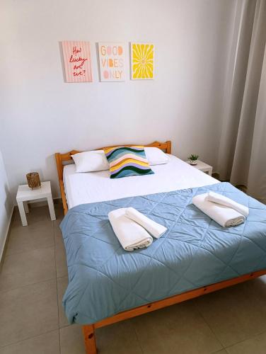 a bedroom with two beds with towels on them at Canvista in Leptokarya