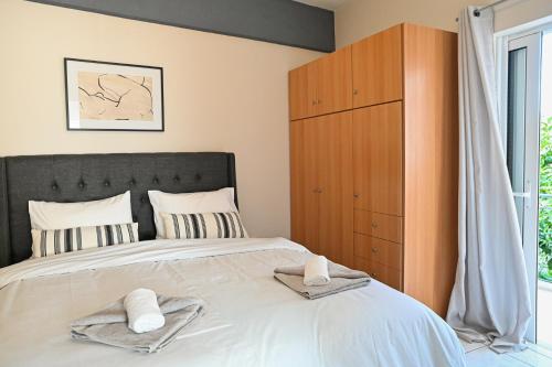 a bedroom with a large bed with towels on it at CALLI HOUSE in Preveza