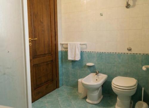 a bathroom with a toilet and a sink at House Betania in San Ferdinando