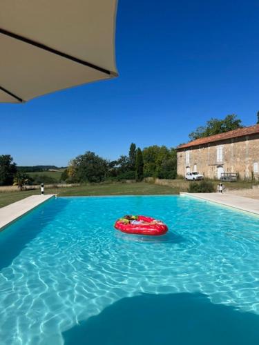 a red toy in the middle of a swimming pool at Saint Germain - Logis de Beaulieu in Poullignac