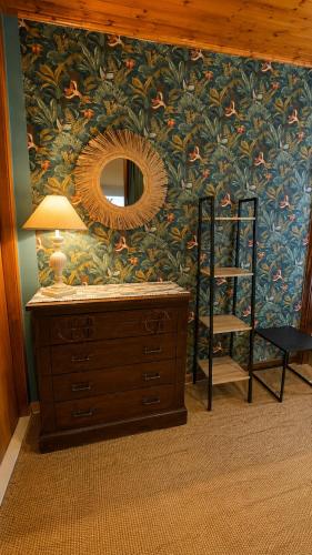 a room with a wall with a mirror and a dresser at Villa Incanto on the Sea in Syracuse