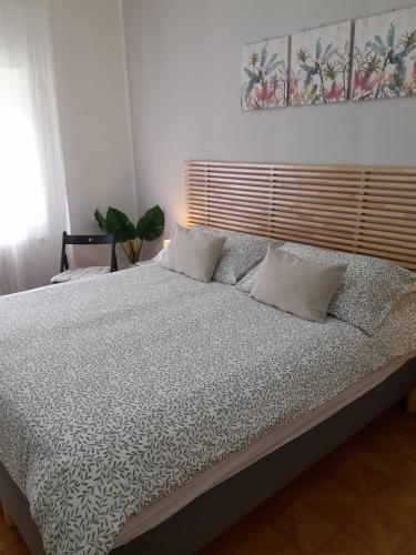 a bedroom with a large bed with white sheets and pillows at BGM apartment Rho Fiera Milan in Cesate