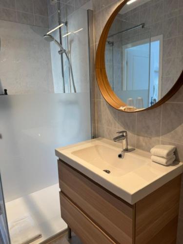 a bathroom with a sink and a mirror at L'arbre qui chante in Saint-Étienne-de-Sermantin