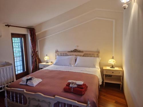 a bedroom with a bed with two towels on it at Linda's Retreat in Fiano Romano
