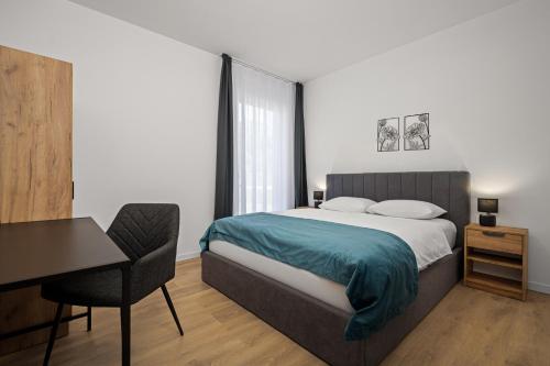 a bedroom with a bed and a desk and a chair at Villa Vallis in Nedeščina