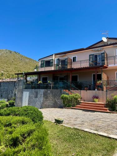a house on a hill with a patio at B&B Saracinello in Praia a Mare