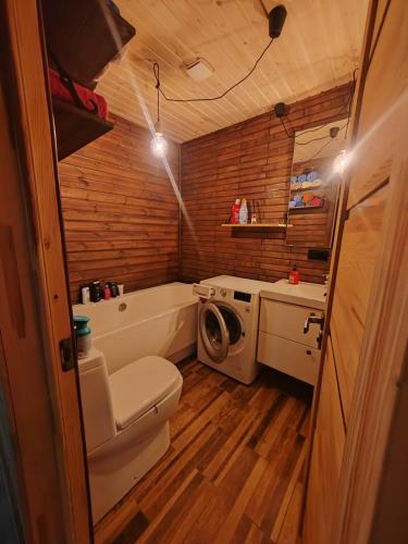 a bathroom with a tub and a toilet and a sink at Family vacations house in Tīnūži