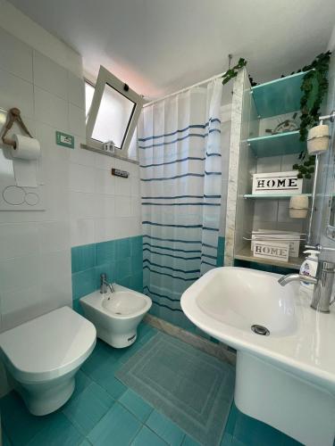 a bathroom with a sink and a toilet and a sink at L'Angolo Vacation Home in Nerano