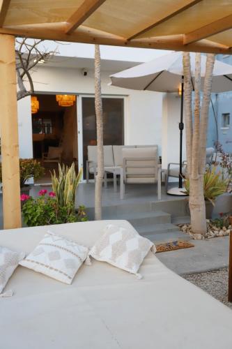 a white bed with a bow tie on top of it at Cozy beach house in Perivolia