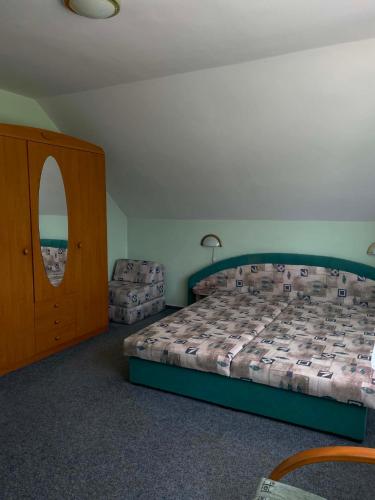 a bedroom with a bed and a dresser and a door at Pension Doris in Velká Hleďsebe