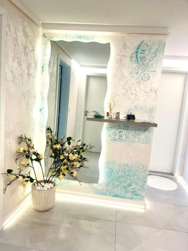 a room with a window and a vase with a plant at Balkan tower REST 2 Безплатно паркомясто in Gabrovo