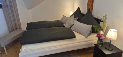a bed with pillows on it in a room at Haus Neubauer in Giengen an der Brenz