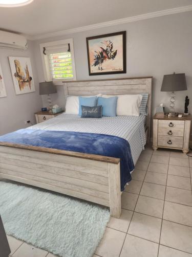 a bedroom with a large bed with blue and white pillows at Millsborough B&B in Billy Dun