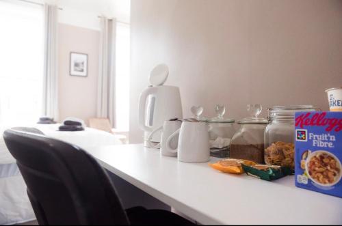 a white counter with a table with food on it at Ship Inn in Wylam
