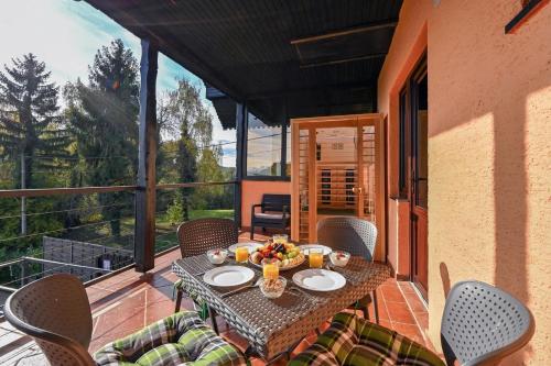 a patio with a table and chairs on a balcony at Twin Oasis Retreat with Pool & Spa - Happy Rentals in Biškupec Zelinski