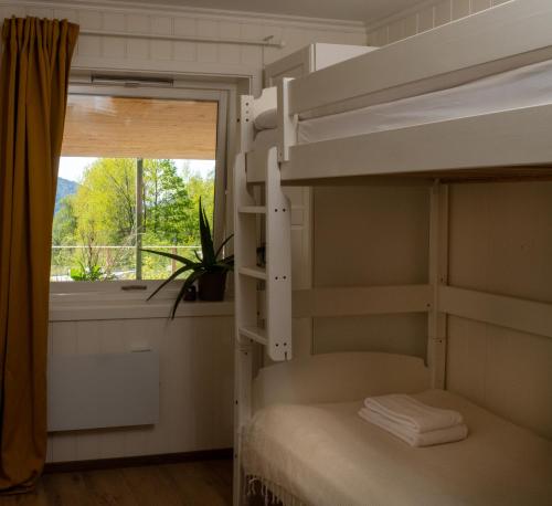 a bunk bed in a room with a window at Fjellhagen in Bjørkheim