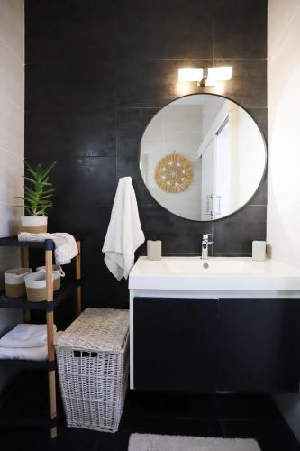 a bathroom with a sink and a mirror at Cozy beach house in Perivolia