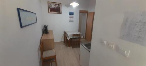 a room with a kitchen with a sink and a table at Marijana - One bedroom with balcony in Babino Polje
