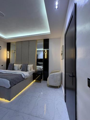 a hotel room with a bed and a chair at JKB PREMIUM lUXURY in Lekki