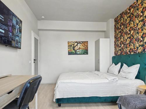 a bedroom with a bed and a desk and a painting at Konstanzer Q - City Studio - Palas Mall - AC in Iaşi